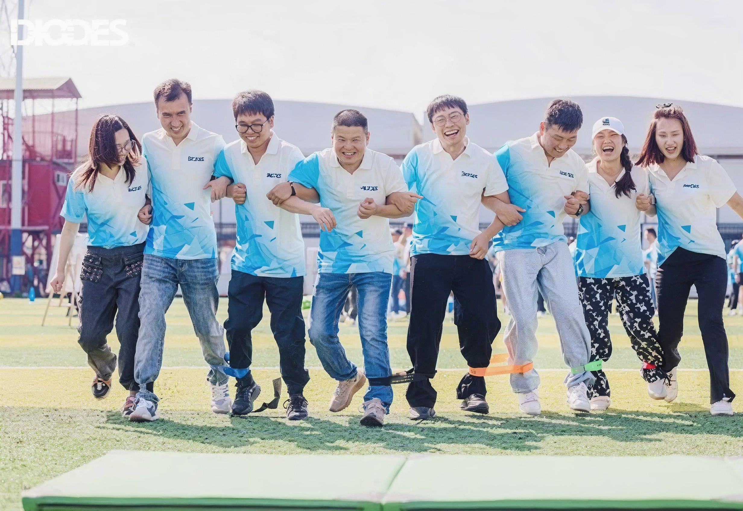 Diodes employees in branded shirts at a company event